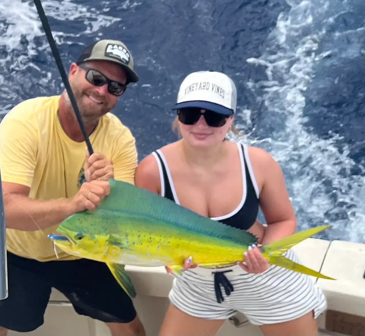 Couple with a vibrant mahi-mahi catch