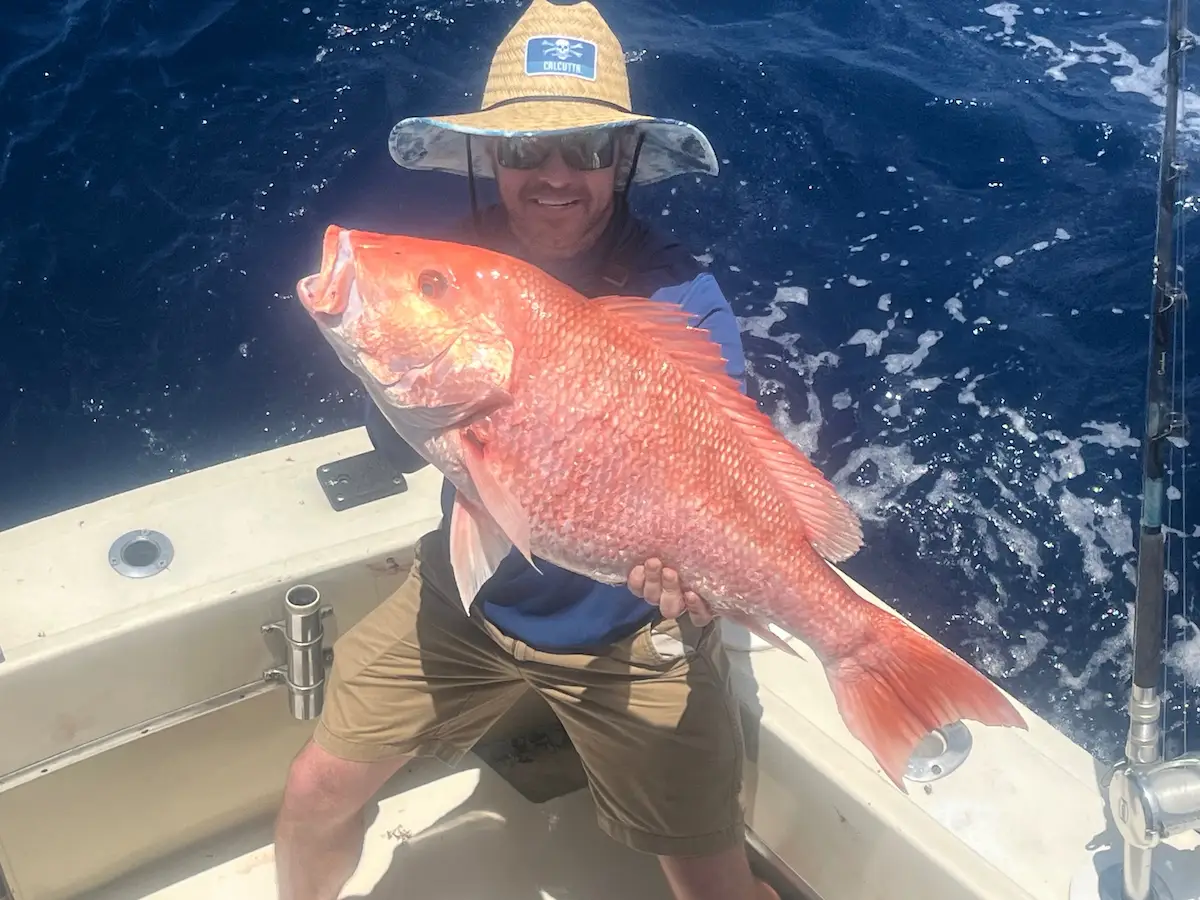 Angler holding a beautiful red snapper offshore